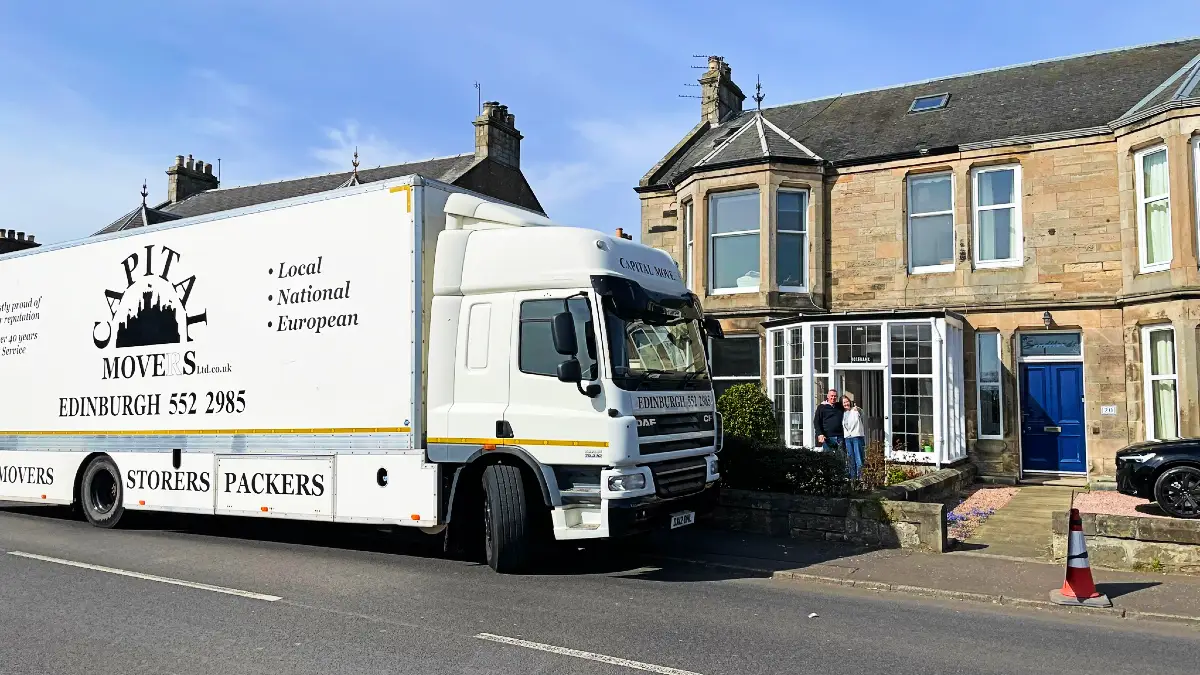Capital Movers large truck with branding on an Edinburgh residential street, highlighting local removals expertise in historic areas.